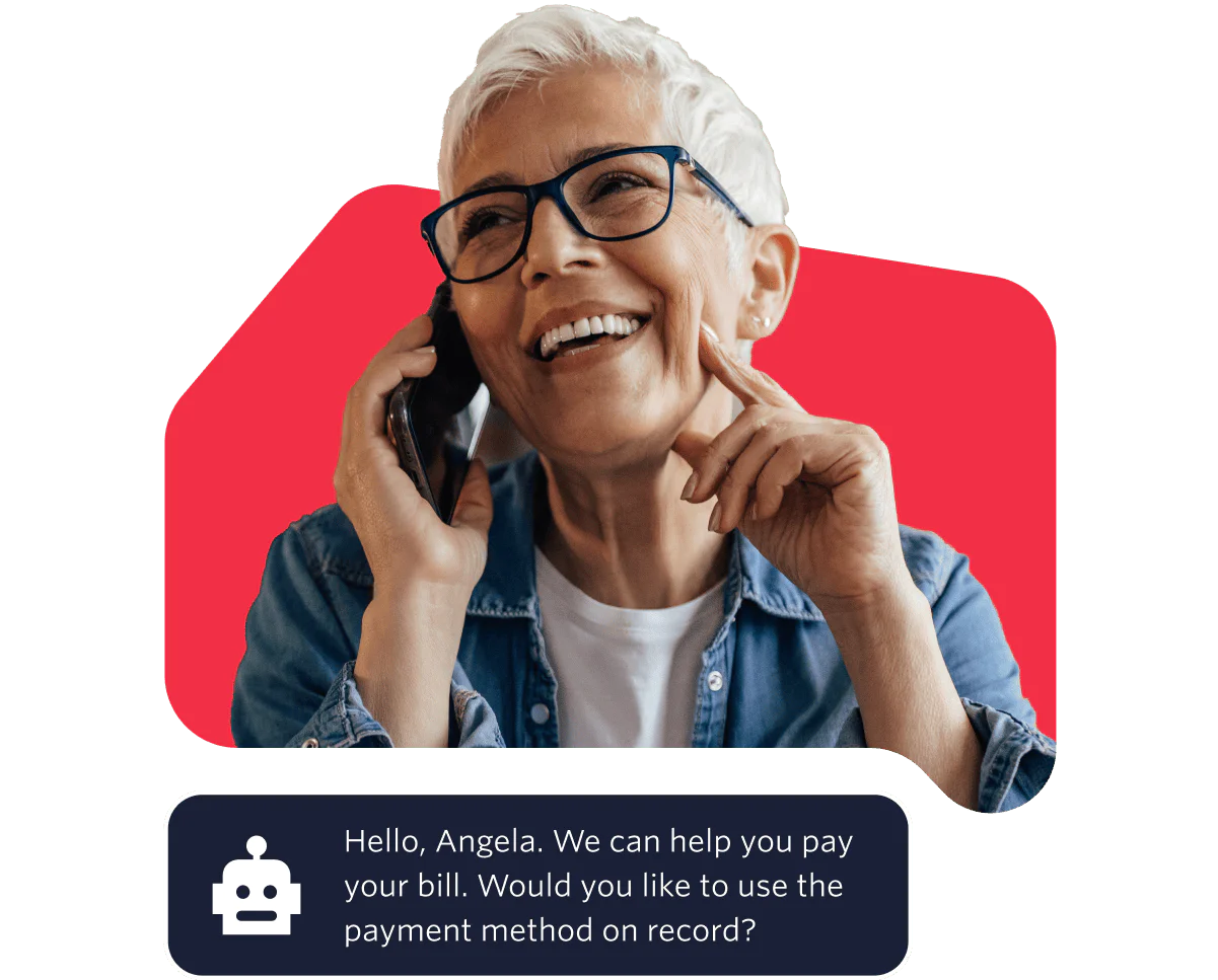 Elderly woman with glasses smiling while talking on the phone against a red background.